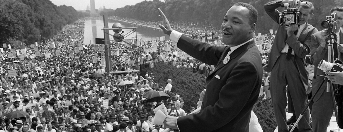 Martin Luther King, Jr. waves to supporters from the steps of th